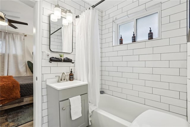 full bath featuring vanity, shower / bath combination with curtain, toilet, and a ceiling fan