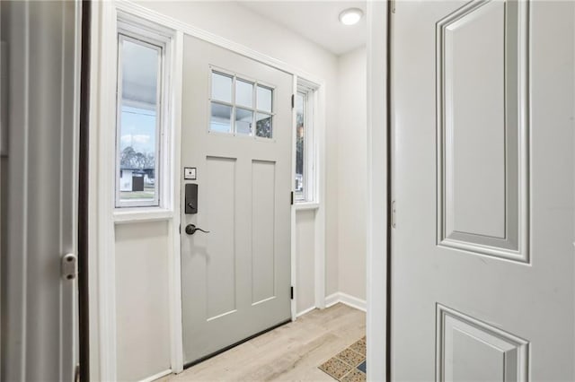 entrance foyer with light wood finished floors and baseboards