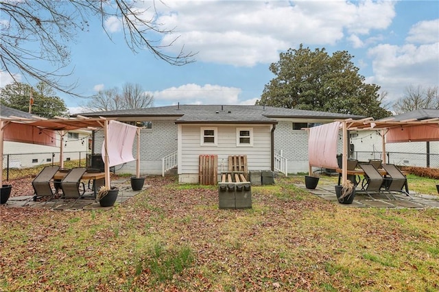 rear view of house featuring fence, a lawn, and a patio