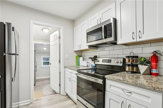 kitchen featuring white cabinetry, tasteful backsplash, and appliances with stainless steel finishes