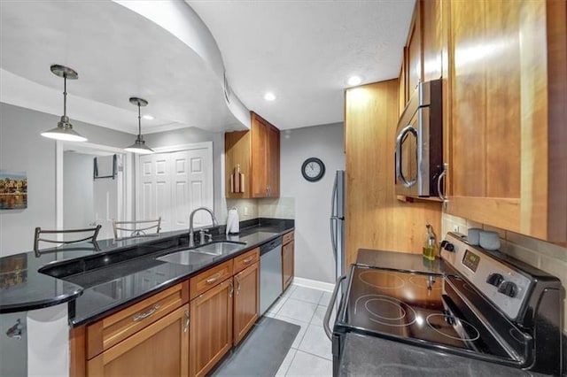 kitchen with sink, light tile patterned floors, hanging light fixtures, stainless steel appliances, and tasteful backsplash