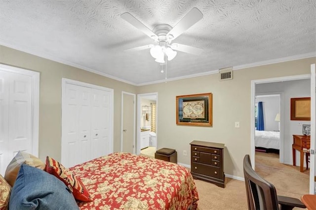 bedroom featuring multiple closets, ceiling fan, light colored carpet, and a textured ceiling