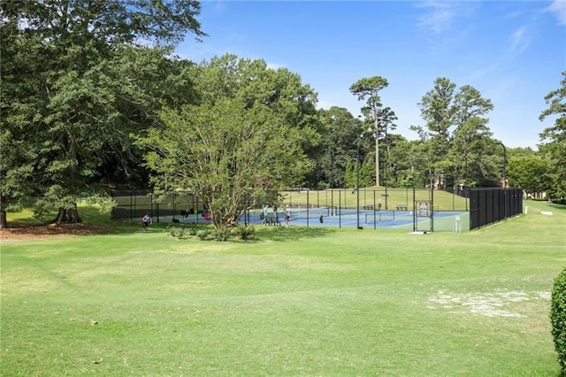 surrounding community with a yard and tennis court