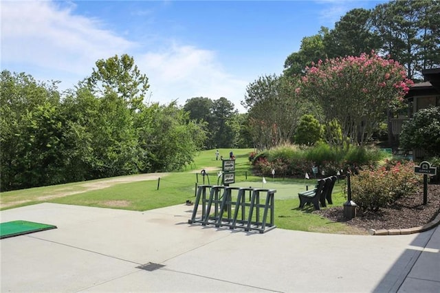 view of community with a yard and a patio