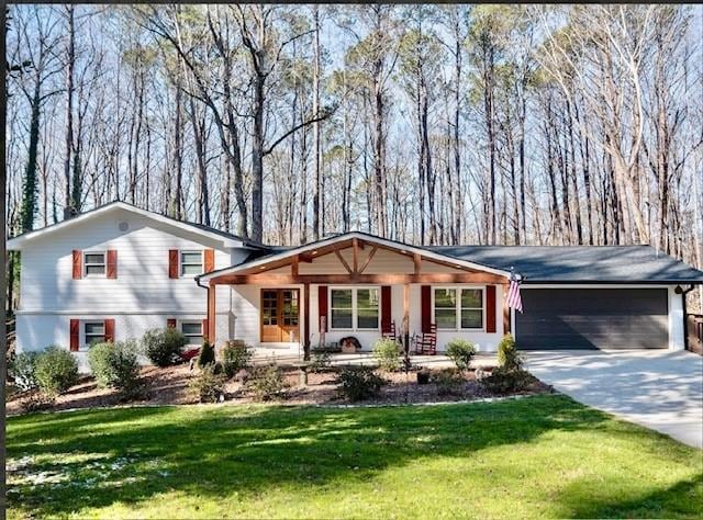 view of front of house featuring a garage, covered porch, and a front yard