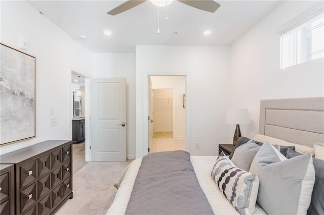 bedroom featuring light carpet, connected bathroom, and ceiling fan