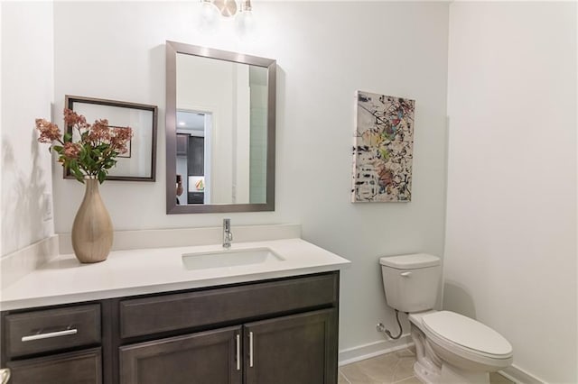 bathroom featuring tile patterned flooring, vanity, and toilet