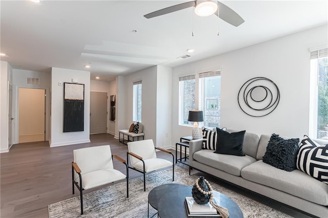 living room featuring wood-type flooring and ceiling fan