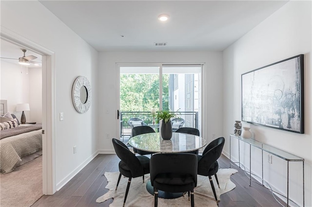 dining area with dark hardwood / wood-style flooring