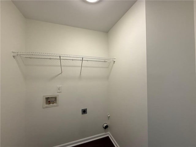 clothes washing area featuring electric dryer hookup, hookup for a washing machine, and baseboards