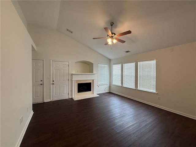 unfurnished living room featuring a ceiling fan, baseboards, a premium fireplace, dark wood-style flooring, and vaulted ceiling