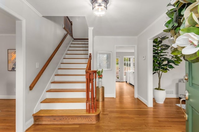 entrance foyer featuring light wood-type flooring and ornamental molding