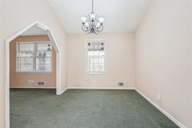spare room with carpet, visible vents, baseboards, and an inviting chandelier