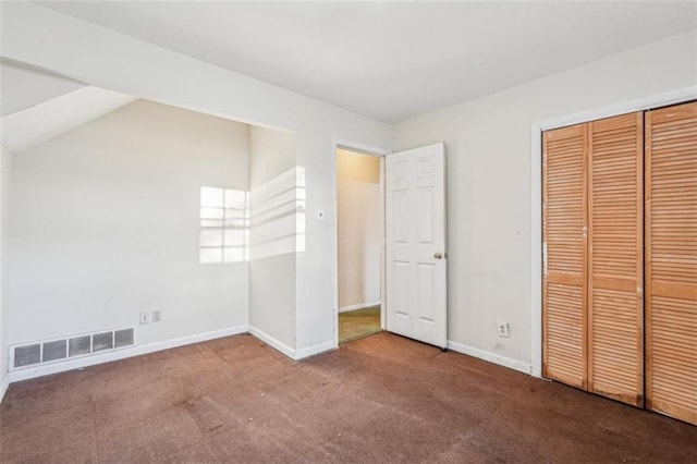 unfurnished bedroom featuring baseboards, visible vents, carpet, and a closet