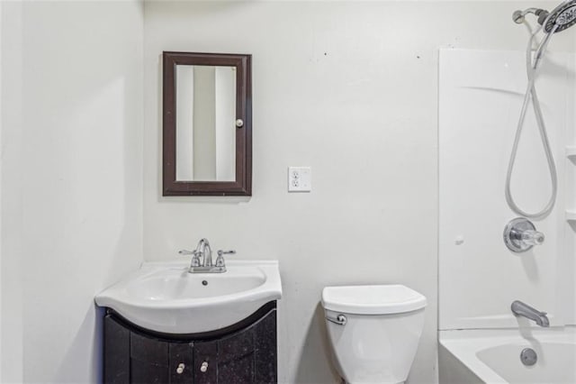 bathroom featuring tub / shower combination, toilet, and vanity