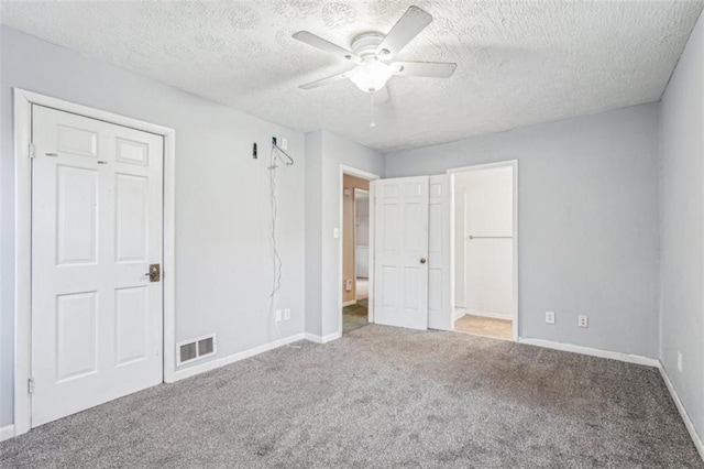 unfurnished bedroom featuring baseboards, carpet flooring, and visible vents