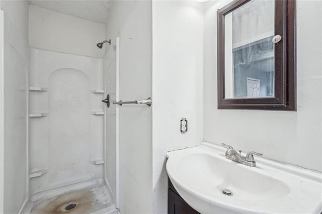 bathroom with vanity and a stall shower