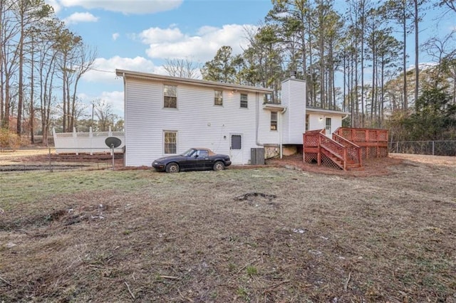 rear view of house featuring central AC unit, stairway, a chimney, a deck, and fence