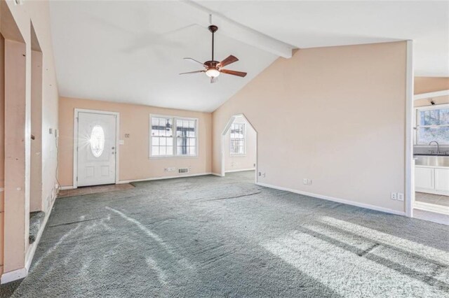 unfurnished living room featuring a sink, baseboards, carpet, and ceiling fan