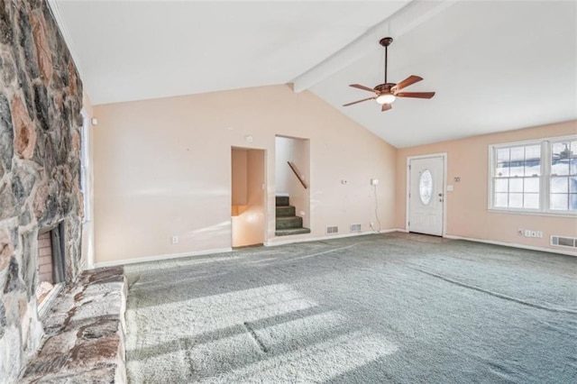 unfurnished living room featuring lofted ceiling with beams, a ceiling fan, carpet flooring, and stairs