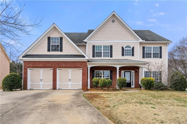 view of front of home with a porch, a garage, brick siding, concrete driveway, and a front yard