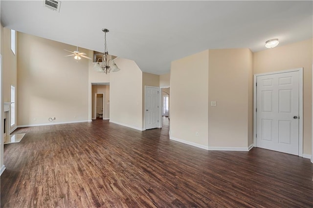 unfurnished living room featuring a fireplace with flush hearth, dark wood-style flooring, visible vents, and baseboards