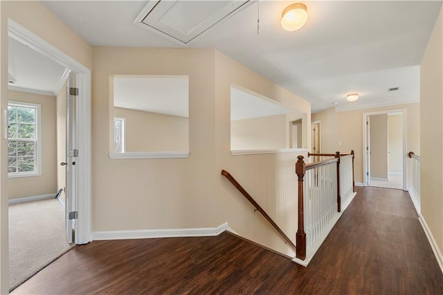 hallway featuring wood finished floors, an upstairs landing, and baseboards