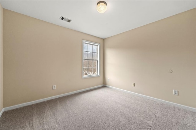 unfurnished room with baseboards, visible vents, and carpet flooring