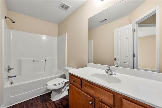 bathroom with toilet, visible vents, wood finished floors, and shower / bathtub combination