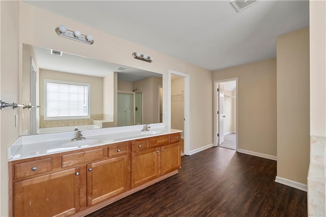 bathroom featuring a stall shower, visible vents, and a sink