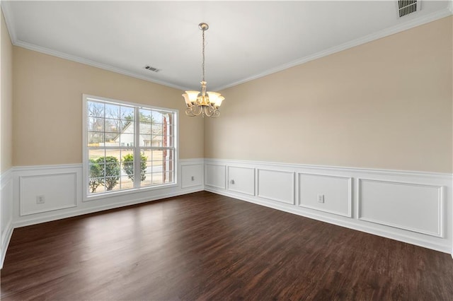 unfurnished room with a chandelier, dark wood-style flooring, visible vents, and ornamental molding