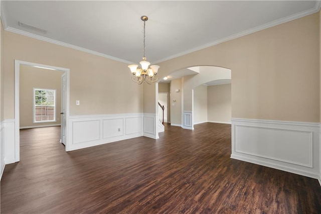 unfurnished room with dark wood-type flooring, arched walkways, visible vents, and ornamental molding