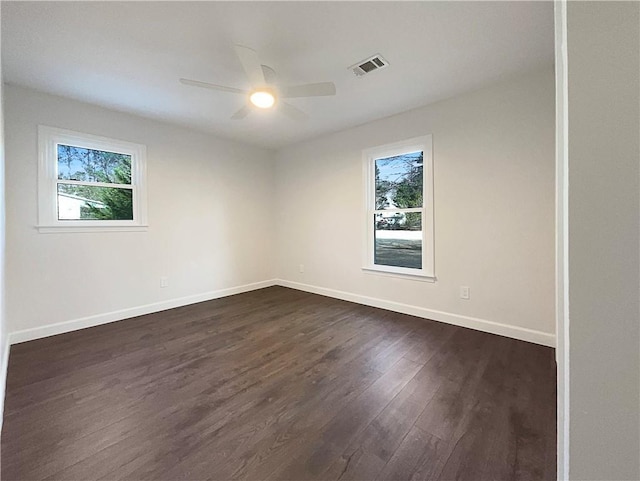 unfurnished room featuring ceiling fan and dark hardwood / wood-style floors