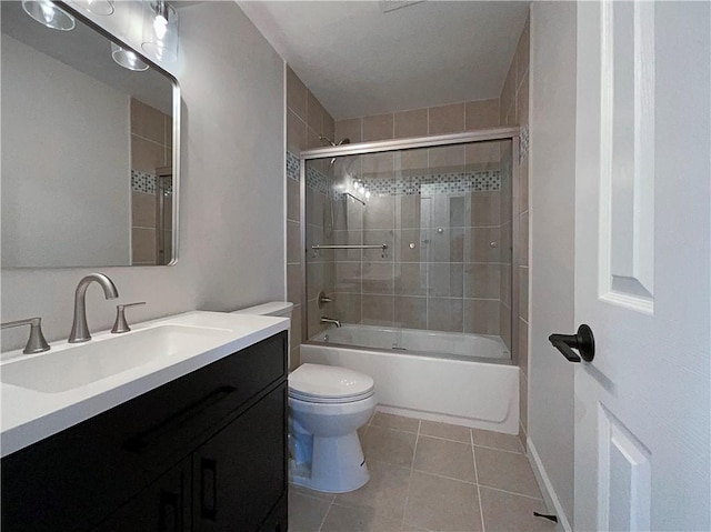 full bathroom with toilet, vanity, shower / bath combination with glass door, and tile patterned flooring