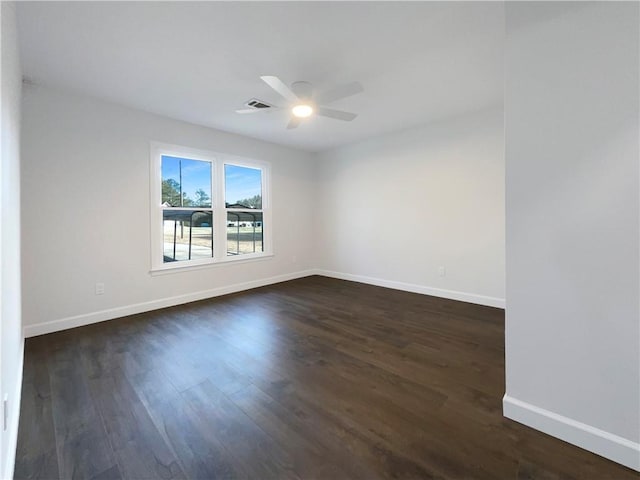 empty room featuring ceiling fan and dark hardwood / wood-style flooring