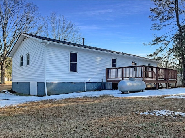 snow covered property featuring a deck and central AC