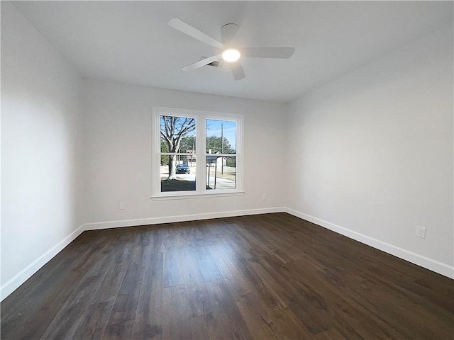 empty room with dark wood-type flooring and ceiling fan