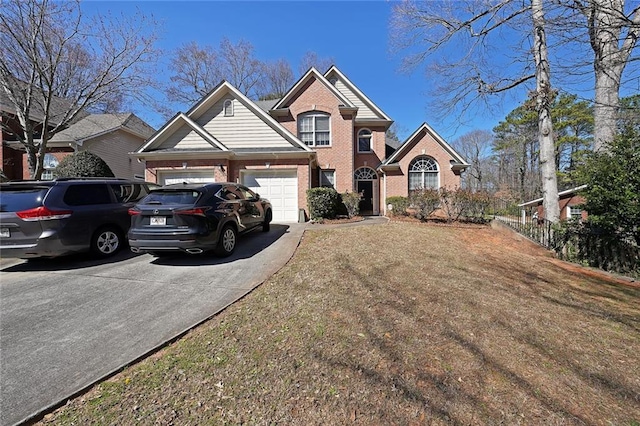 view of front facade with driveway, an attached garage, and brick siding