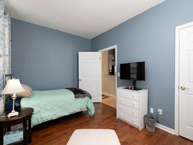 bedroom featuring dark wood-type flooring