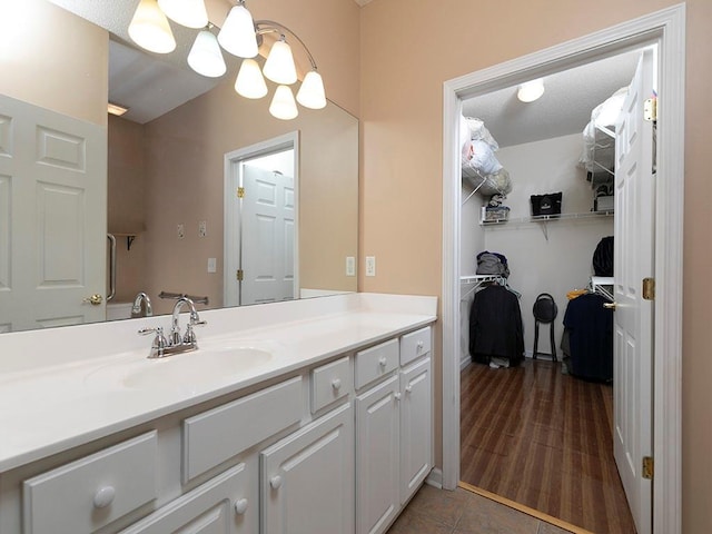 bathroom featuring a textured ceiling, vanity, and hardwood / wood-style flooring