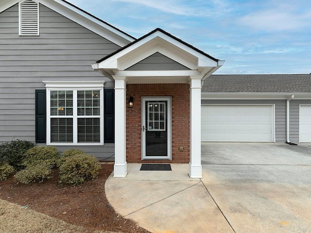 view of exterior entry with a garage