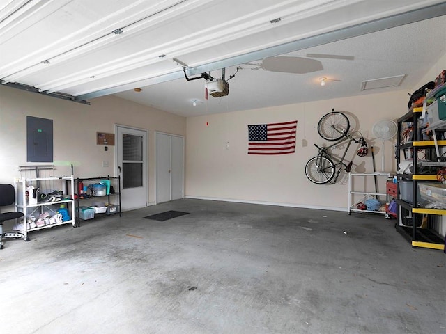 garage with a garage door opener and electric panel