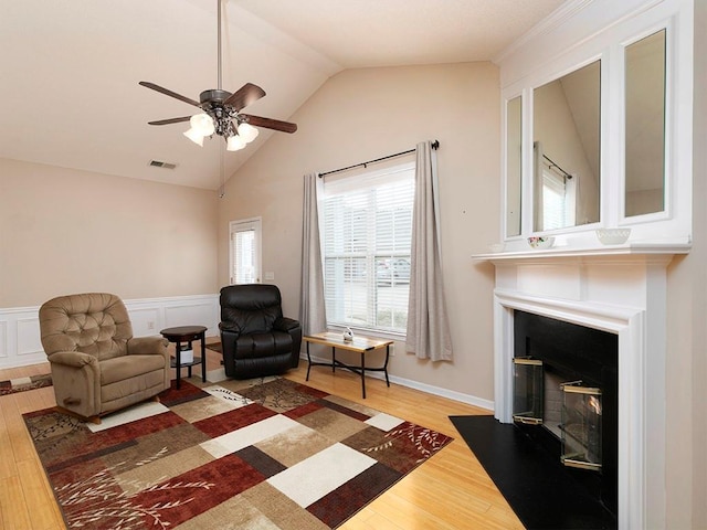 living area featuring ceiling fan, lofted ceiling, and hardwood / wood-style flooring