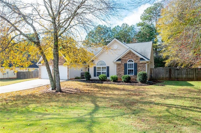 view of front of property featuring a garage and a front yard