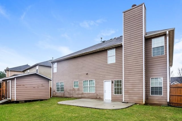 back of house with a patio and a lawn