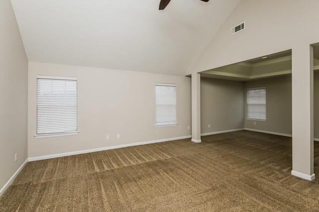 spare room with ceiling fan, high vaulted ceiling, and dark carpet