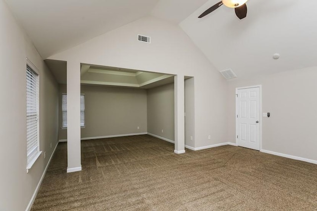 basement featuring dark colored carpet and ceiling fan