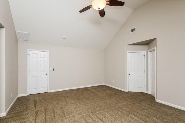 empty room featuring vaulted ceiling, ceiling fan, and dark carpet