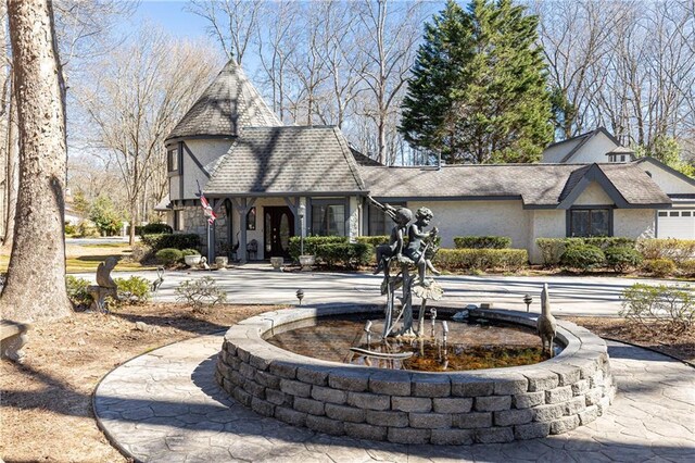 english style home with stucco siding