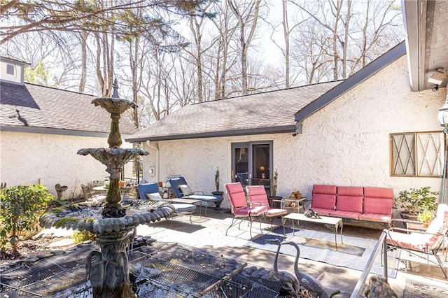 back of house with a patio, a shingled roof, outdoor lounge area, and stucco siding